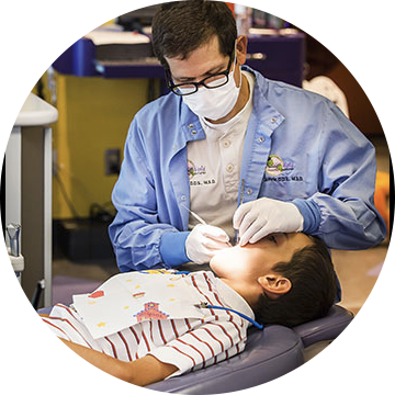 Dr Guthrie examining a patients teeth.