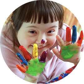 Smiling child with paint on their hands
